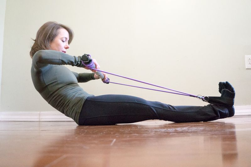 Woman on a reformer with weights